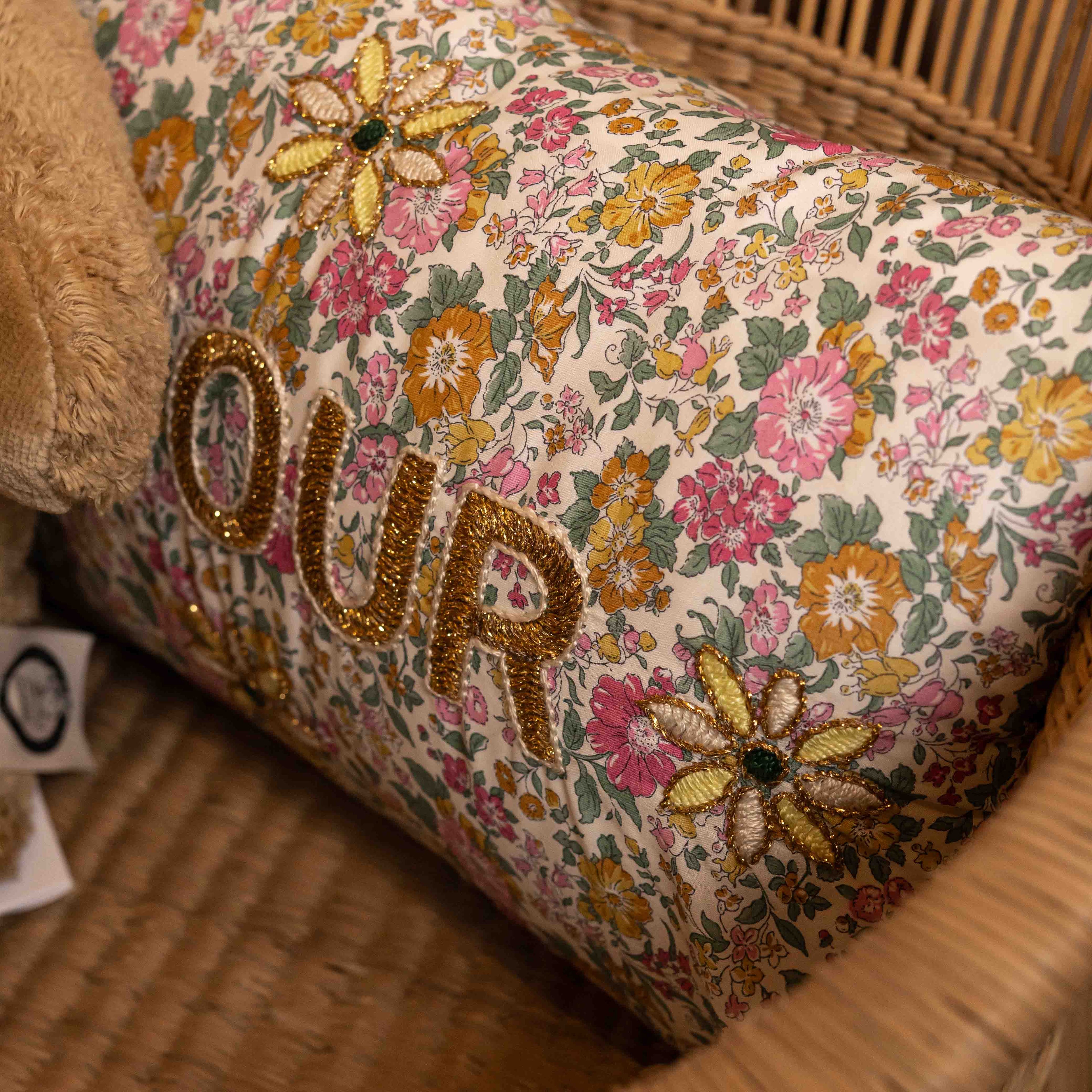 Floral-patterned cushion with embroidered &