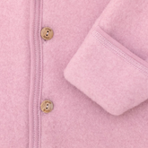Close-up of a pink fleece jacket with button details