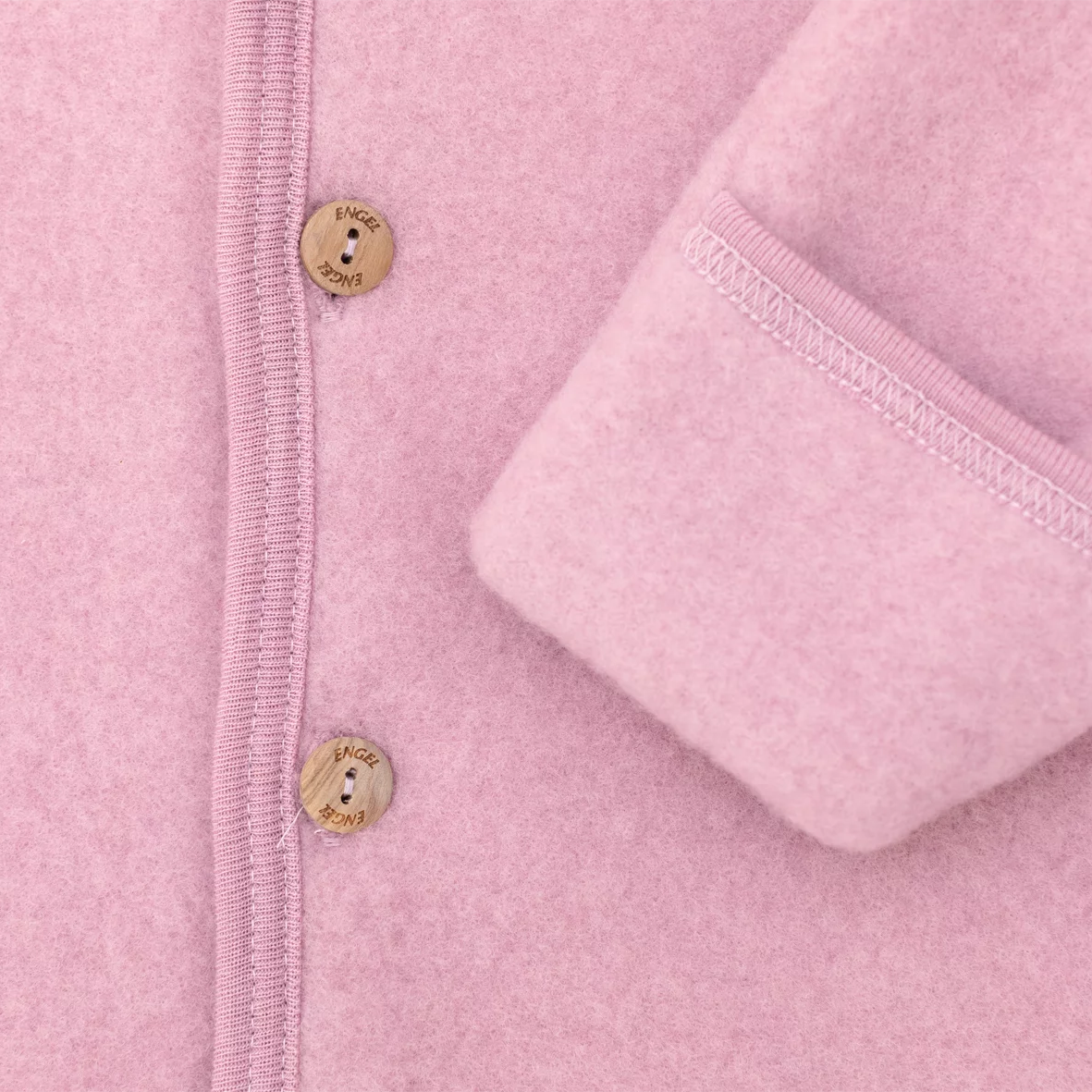 Close-up of a pink fleece jacket with button details