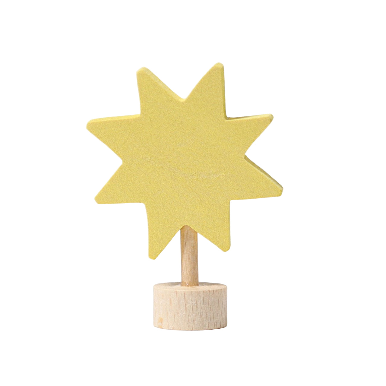 A yellow decorative figure shaped like a star, mounted on a wooden stake.