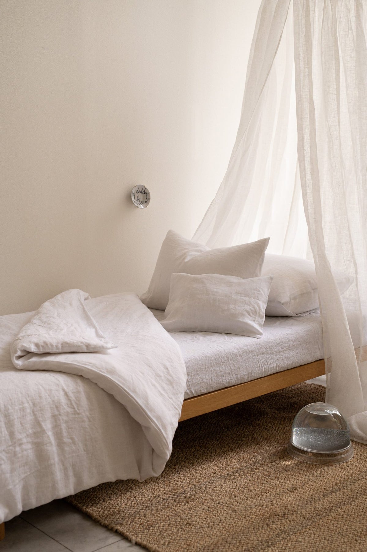 Hazel & George Linen Duvet Cover in Blanc on a single bed with a canopy, styled with pillows