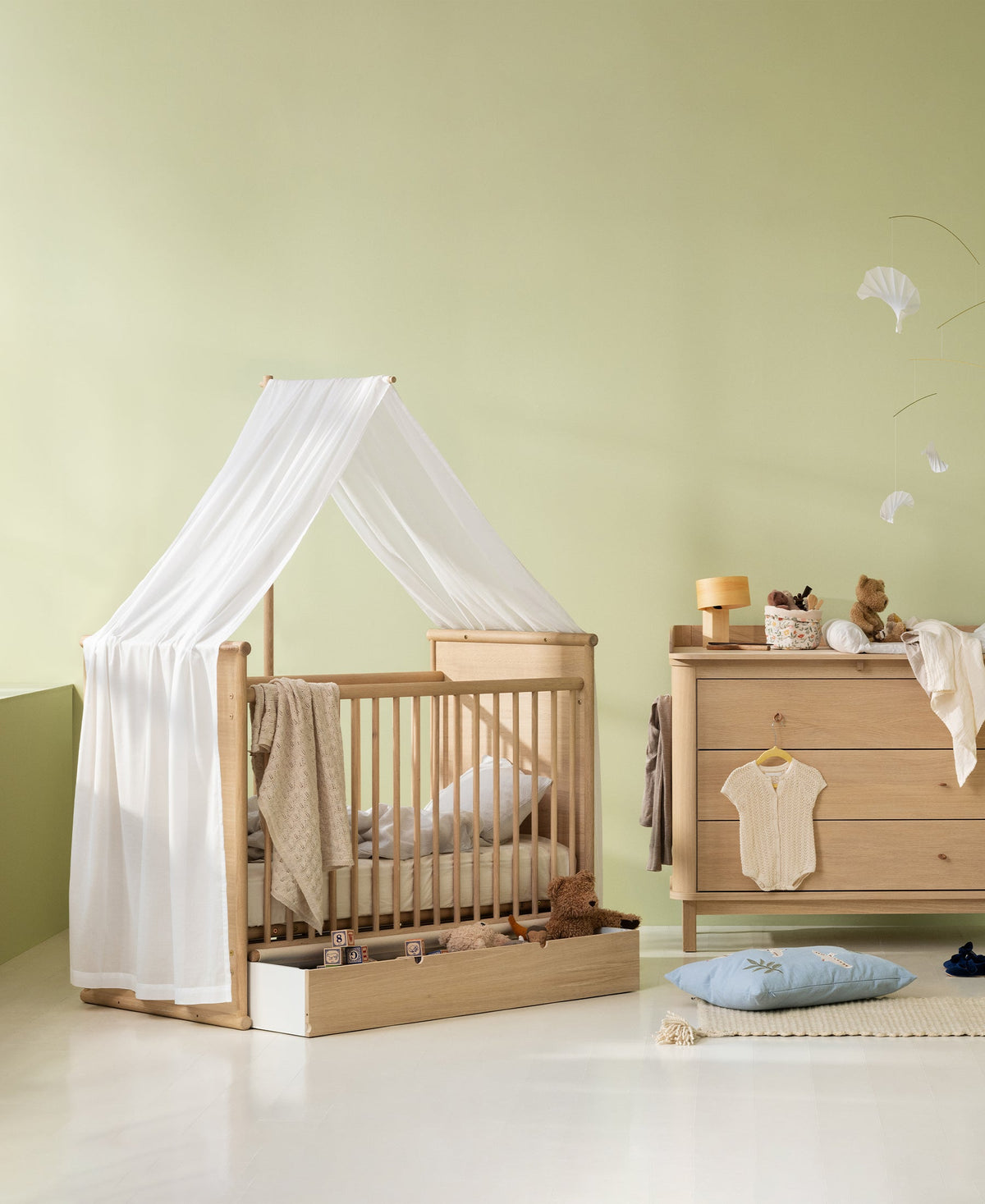 Oliver Furniture Camp Novel transparent white canopy shown on an oak cot