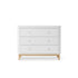 White Oliver Furniture dresser with light oak wood legs on a white background