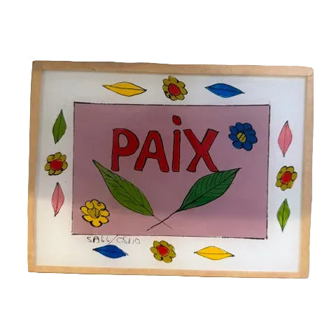 A square glass art plaque featuring the word &