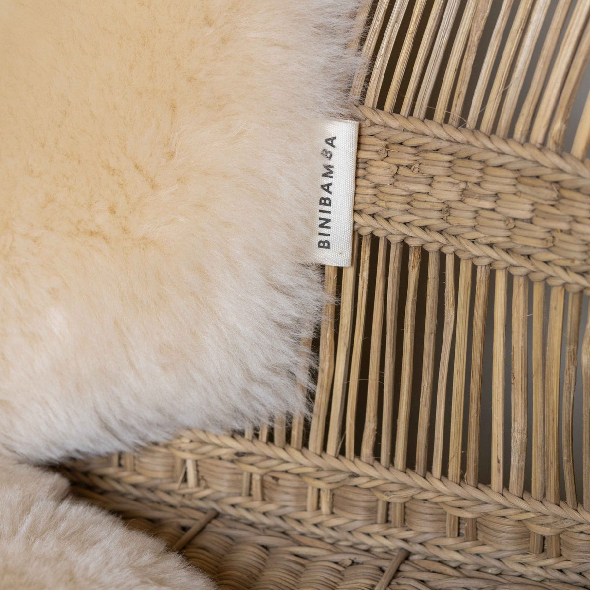 Close-up detail of the Binibamba sheepskin snuggler in Milk