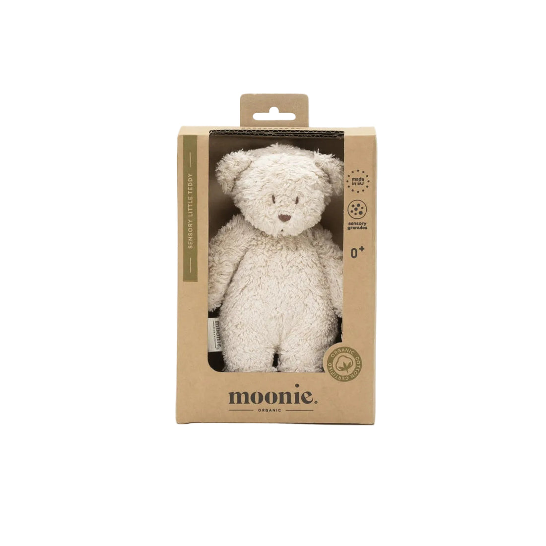 White teddy bear in a cardboard packaging with &