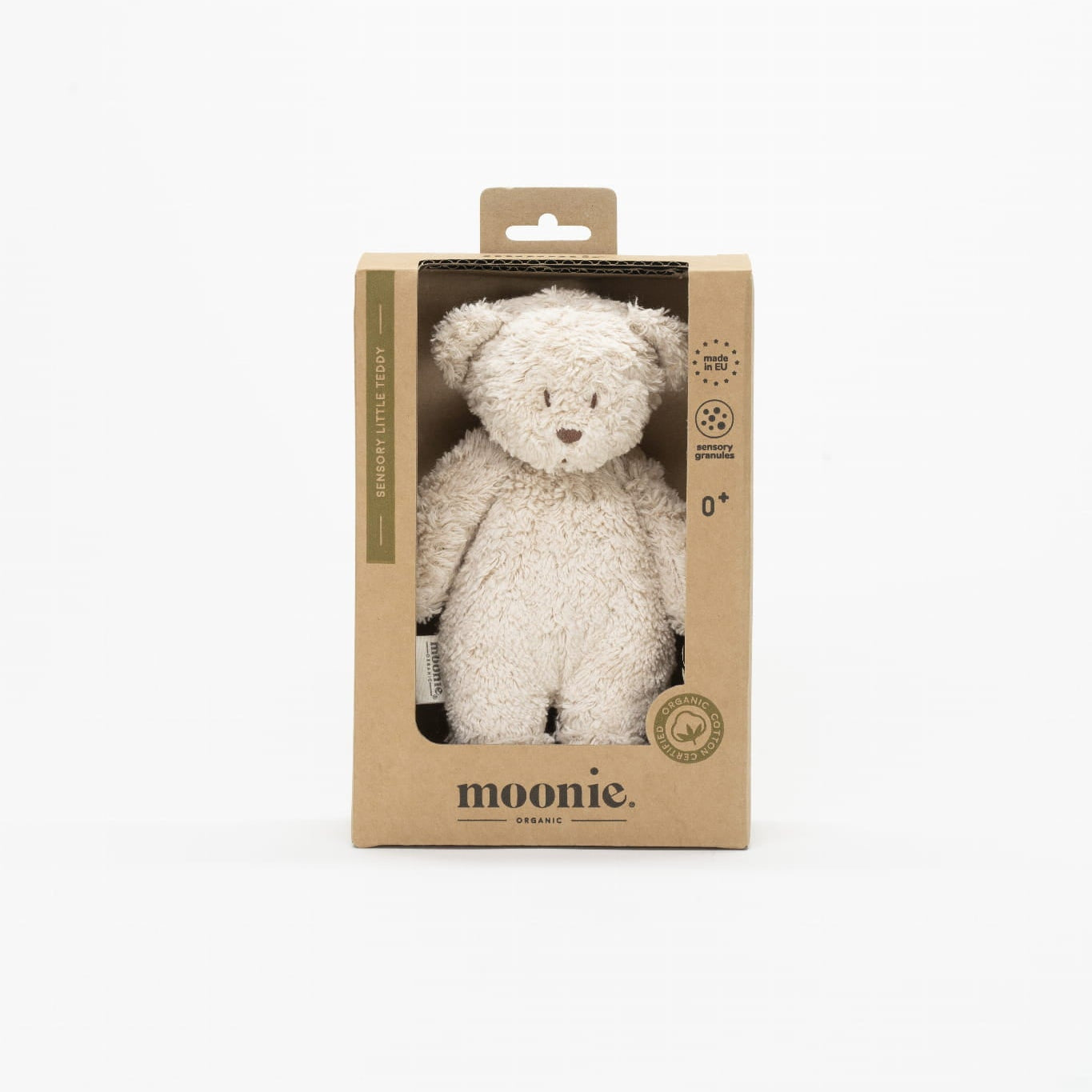 White teddy bear in a cardboard packaging with &