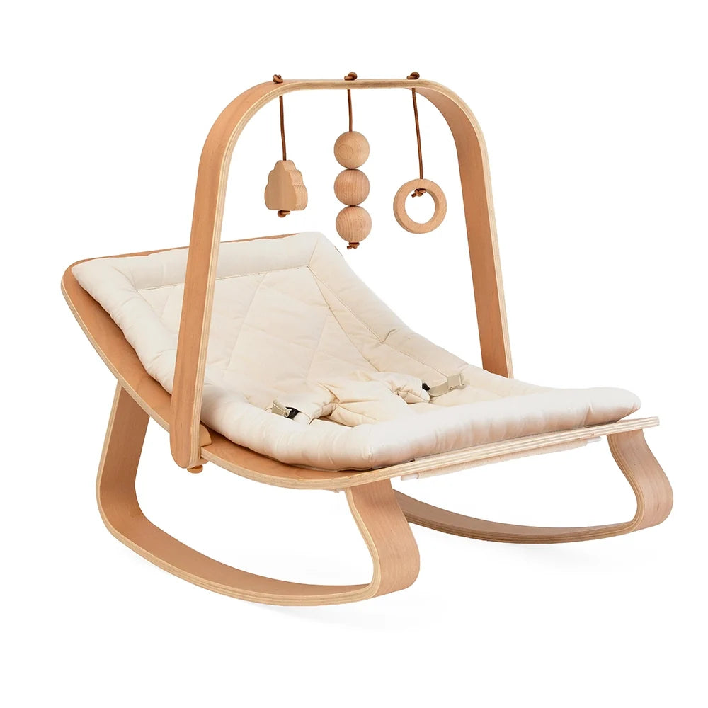 Side view of the Charlie Crane LEVO activity arch in beech wood on the baby rocker