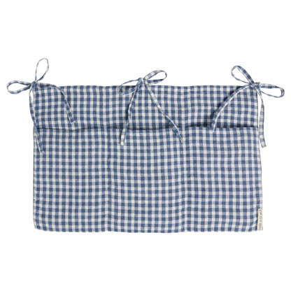 Hazel &amp; George Linen Bed Pocket in Vichy, a linen storage pocket in blue-and-white check with three ribbon ties and three compartments, on a white background