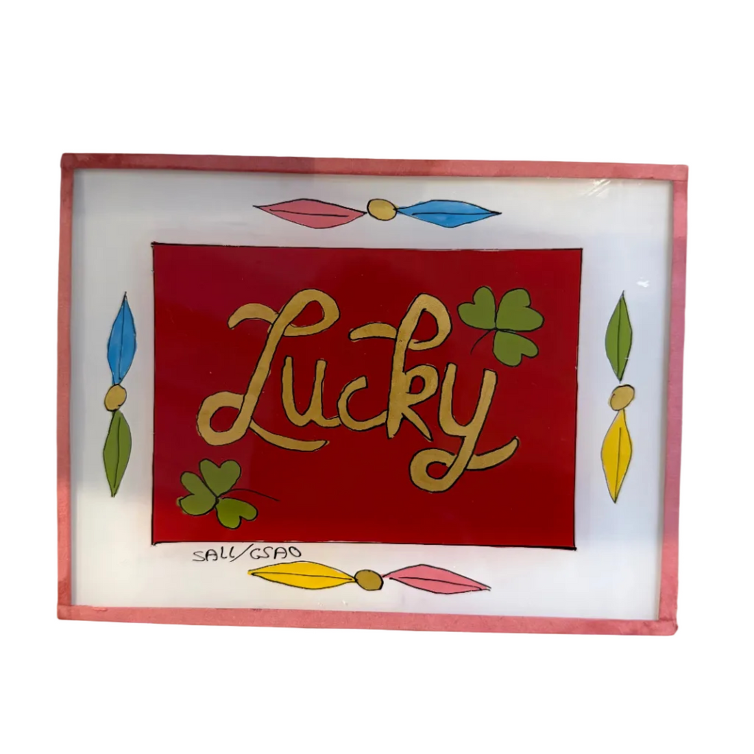 A square decorative art print or plaque with a pink border, featuring a red center with the word &
