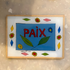 A square glass art plaque featuring a colorful hand-painted design with the word &