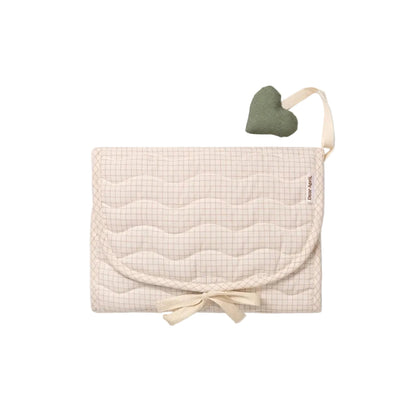 Beige quilted baby blanket with a heart-shaped pillow