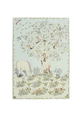 A reversible baby muslin swaddle illustrated with a whimsical forest scene, showing daytime on one side and a magical night scene on the other.