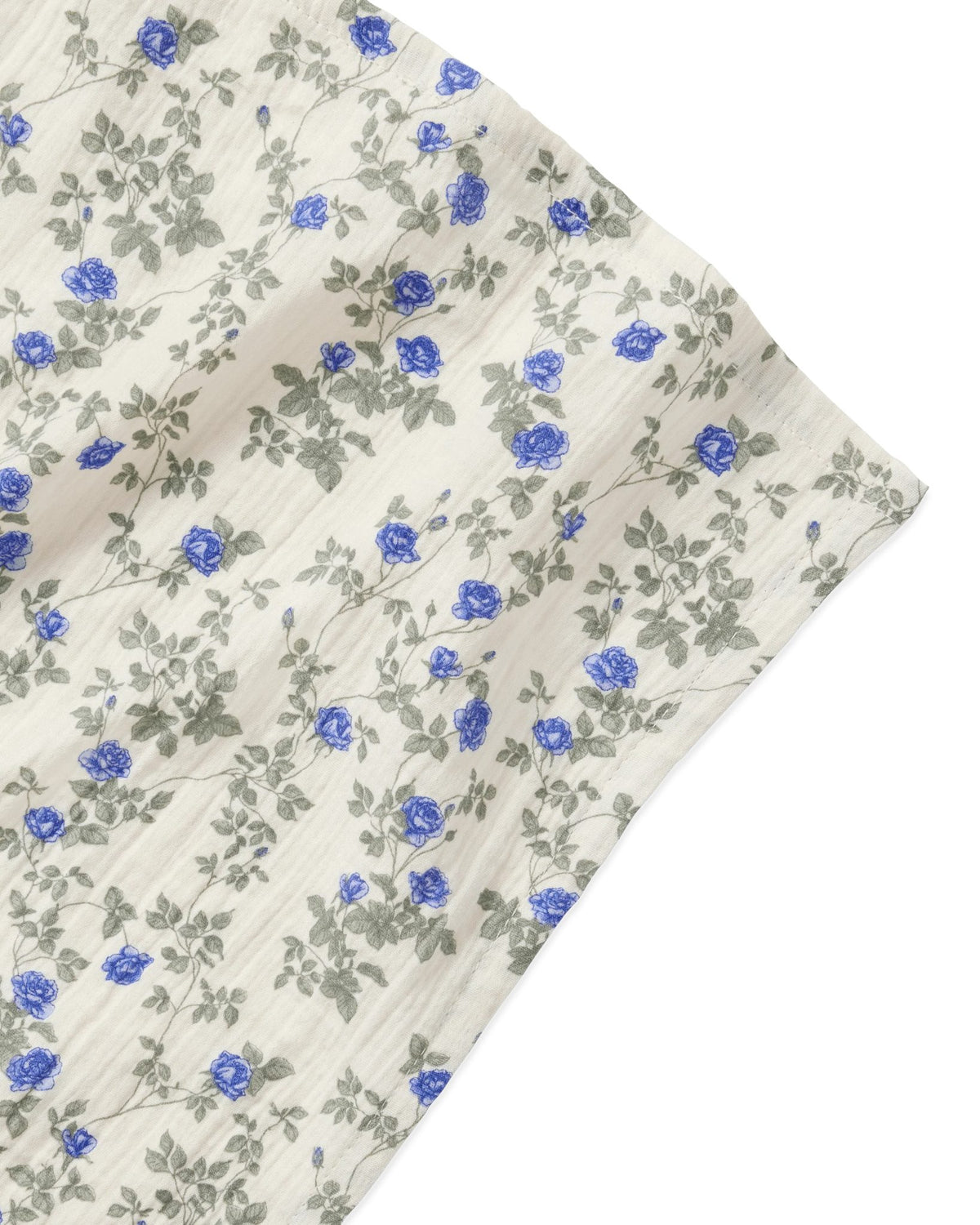 Floral fabric with blue flowers and green leaves on a white background