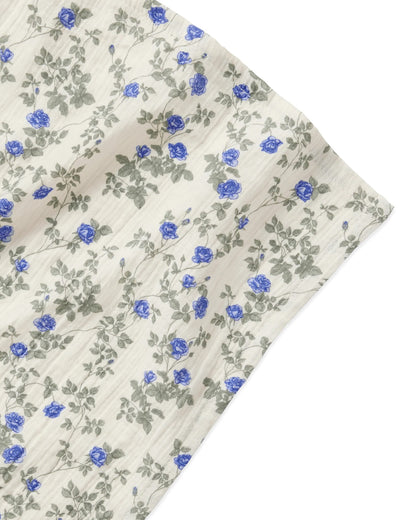 Floral fabric with blue flowers and green leaves on a white background