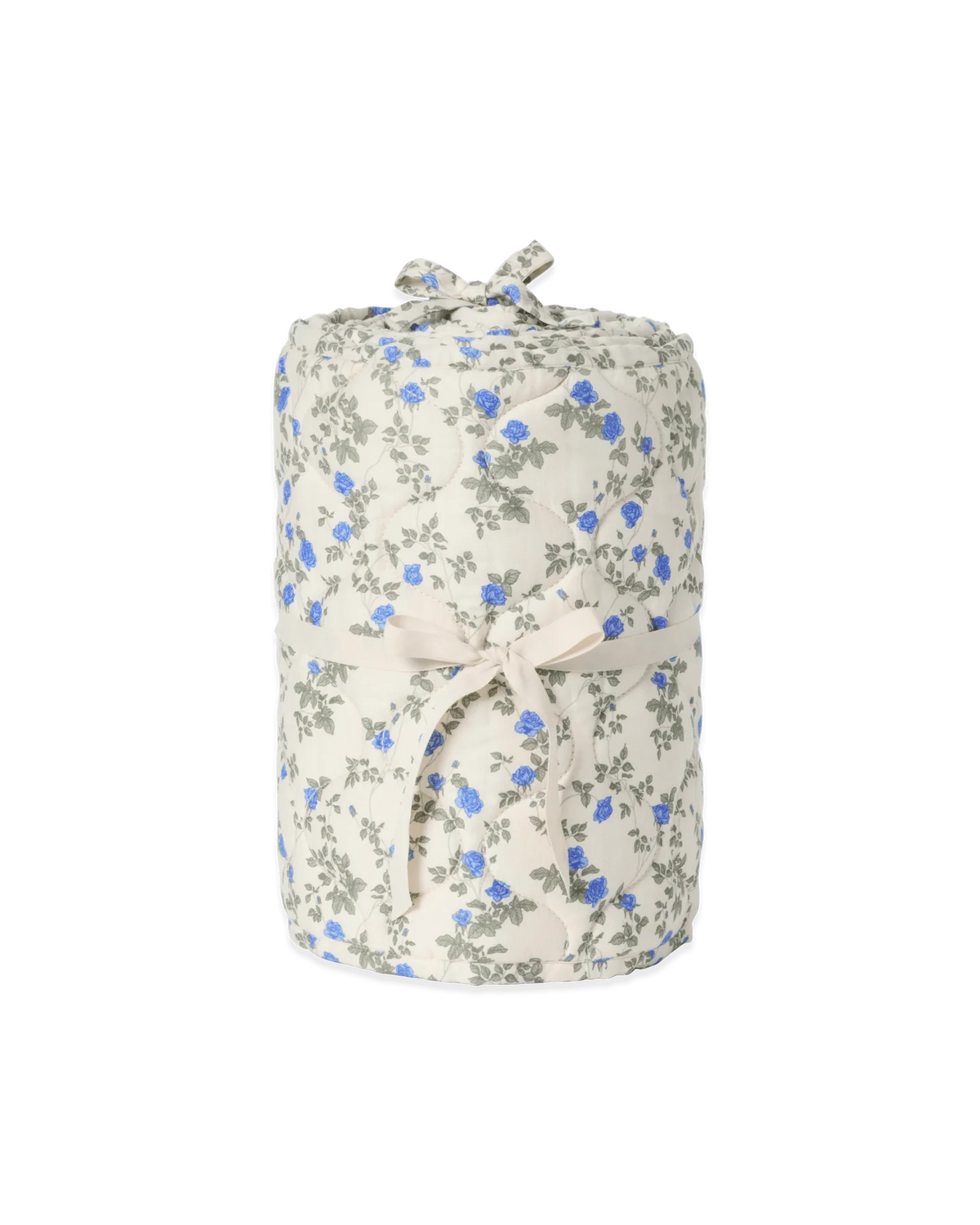 A rolled fabric item, likely a blanket or throw, featuring a delicate blue and gray floral print on a warm cream background, tied with a matching cream ribbon.