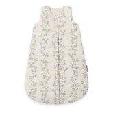 A quilted baby sleep sack in cream with a delicate blue and brown floral vine pattern