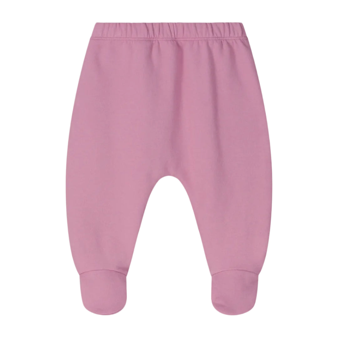 A pair of baby footed pants in a dusty pink color, featuring an elastic waistband and ribbed ankle cuffs