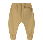 A pair of toddler pants in a warm tan or camel color, featuring an elastic waistband, a side pocket on the right leg, and elasticized cuffs at the ankles.