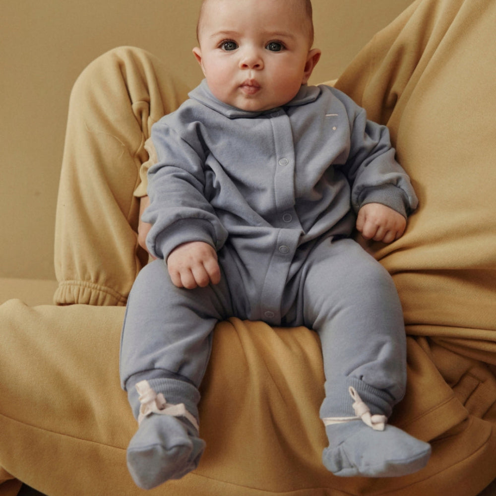 Baby in a gray romper