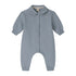 A baby long-sleeve romper in a dusty slate blue color, featuring a Peter Pan collar, snap-button front, and cuffed ankles.