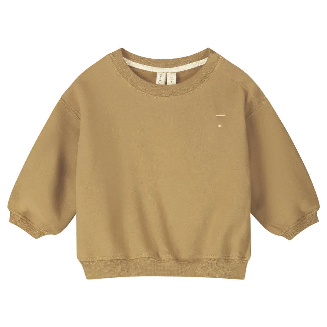 A long-sleeve sweatshirt in a warm camel tan color, featuring a crew neck and a small white embroidered logo on the left chest.