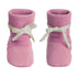A pair of pink knit baby booties with white ribbon bows tied around the ankles