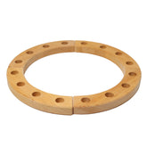 A natural wooden celebration ring with four holes, used for decoration during special occasions.