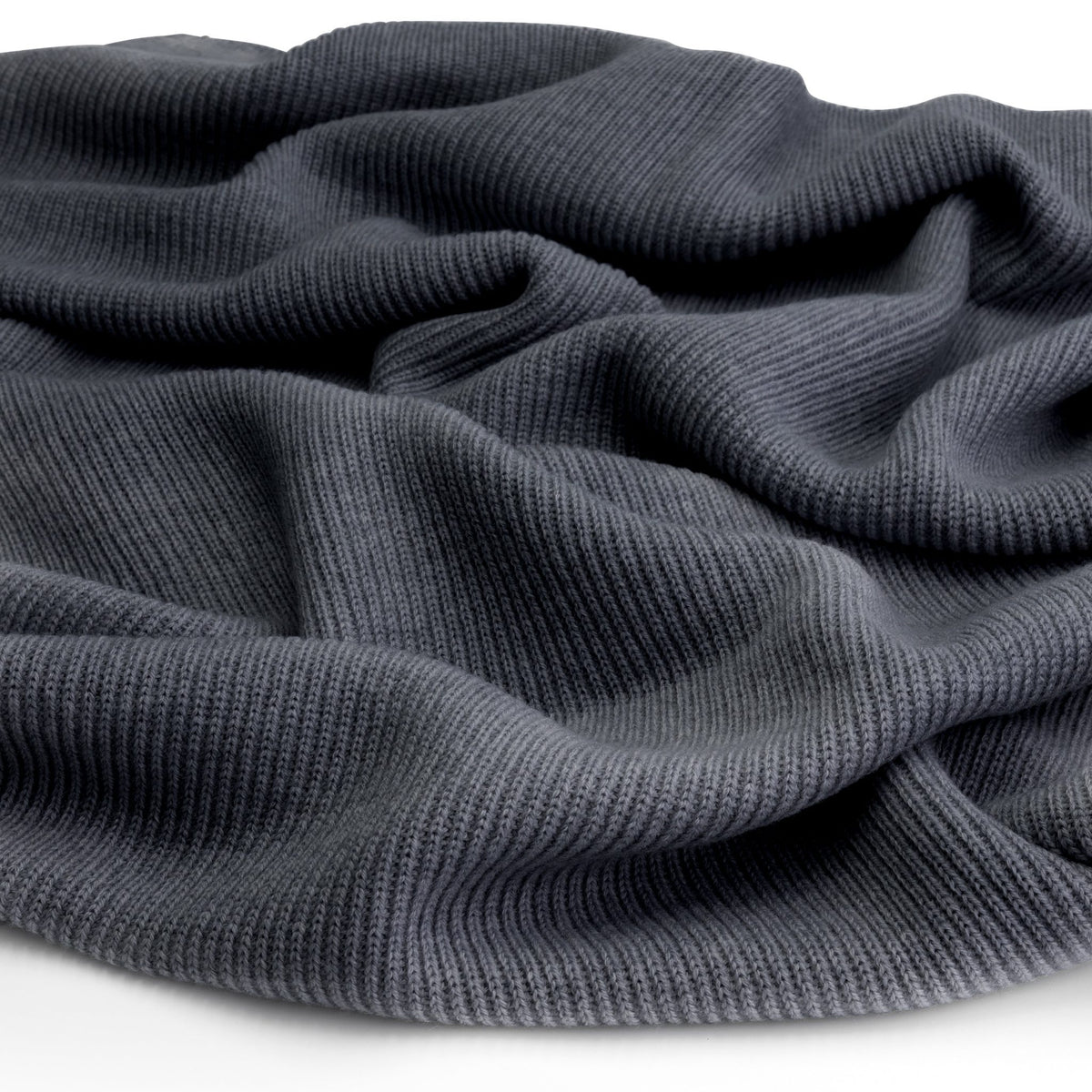 Close-up of the knitted merino wool fabric of a Hazel &amp; George Merino Blanket in Charcoal, draped to show texture
