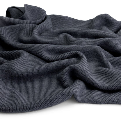 Close-up of the knitted merino wool fabric of the Hazel &amp; George Hazel Merino Baby Blanket in Charcoal, draped on a white background