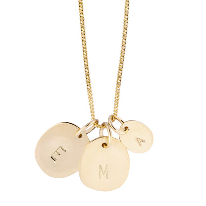 Hazel &amp; George Initial Hanger Large 14K Gold, gold necklace with three pendants engraved with the letters E, M and A in different sizes, on a white background
