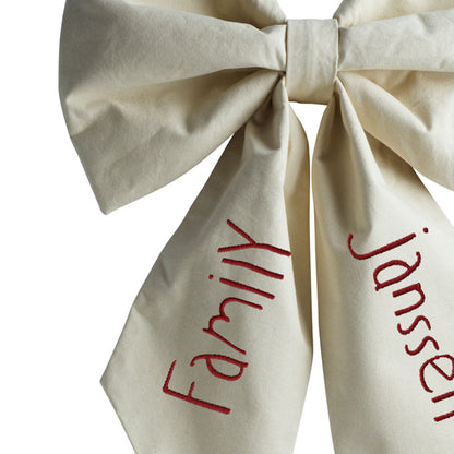 Close-up of the Hazel &amp; George Personalized Festive Bow Large in cream, showing the &