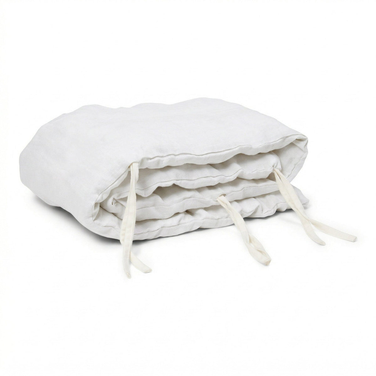 Hazel &amp; George Linen Cover for Cot Bumper in Blanc, a padded linen bumper roll with white ties, folded on a white background