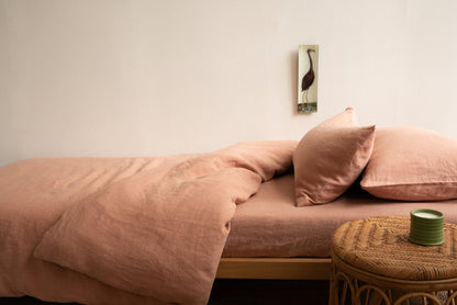 Hazel &amp; George Linen Duvet Cover in Cinnamon on a single bed, styled with pillows