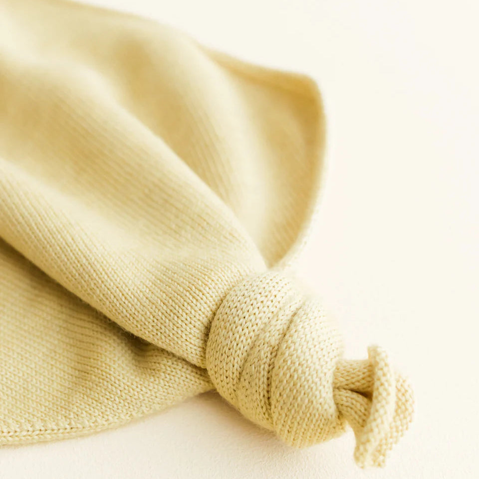 Close-up of a knotted beige fabric on a light background