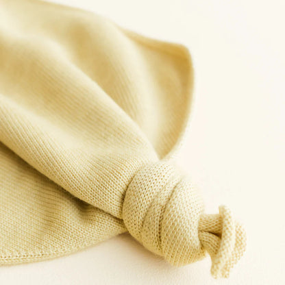 Close-up of a knotted beige fabric on a light background