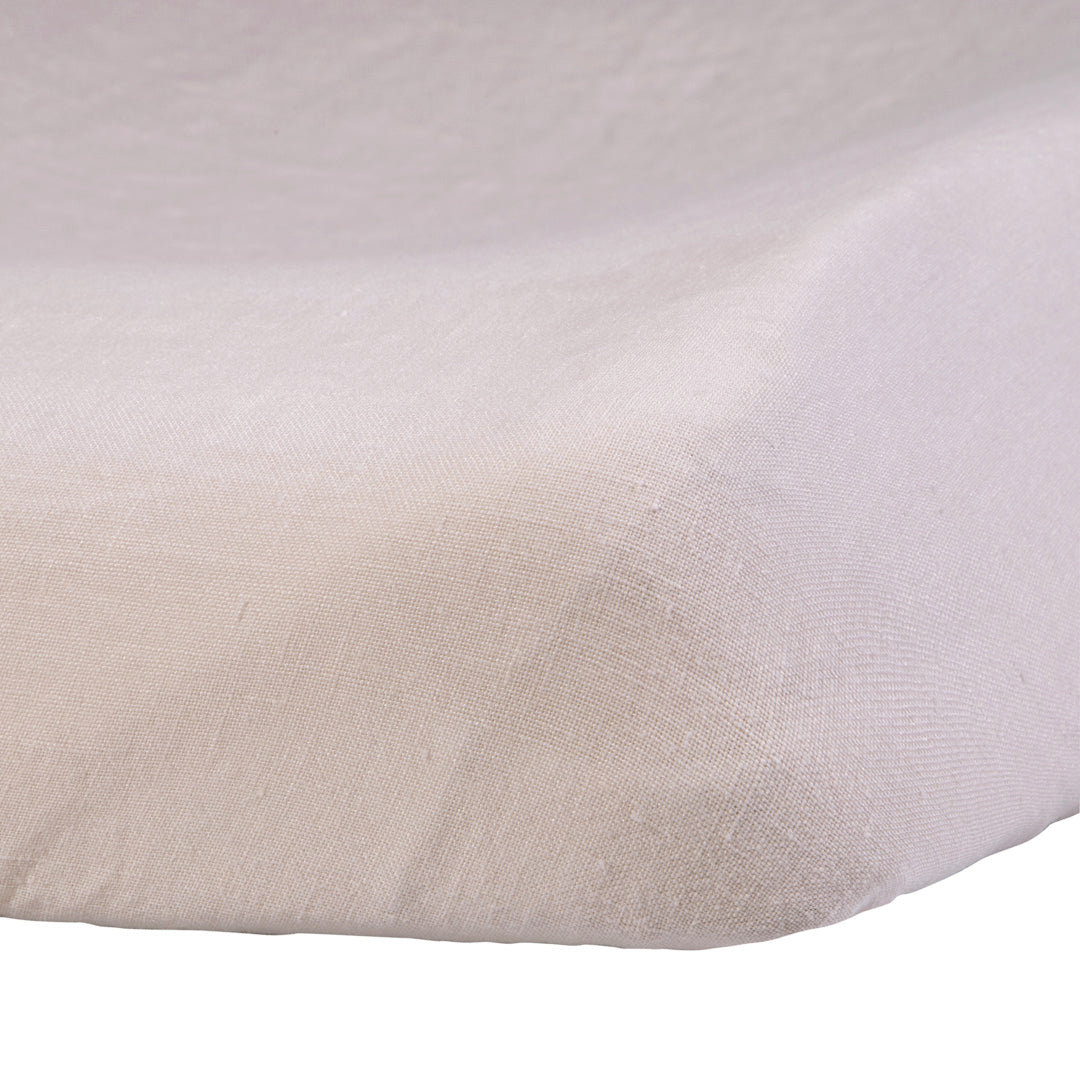 Close-up of the Hazel &amp; George Linen Changing Mat Cover in Craie, showing the fitted corner and natural linen texture