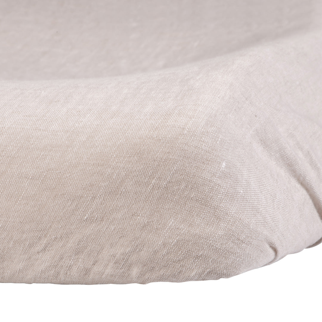 Close-up of the Hazel &amp; George Linen Changing Mat Cover in Naturel, showing the fitted corner and natural linen texture