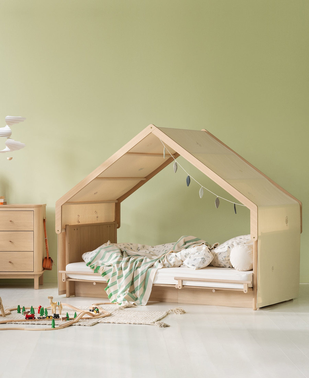 Camp Novel undyed embroidered canopy shown over the oak house bed