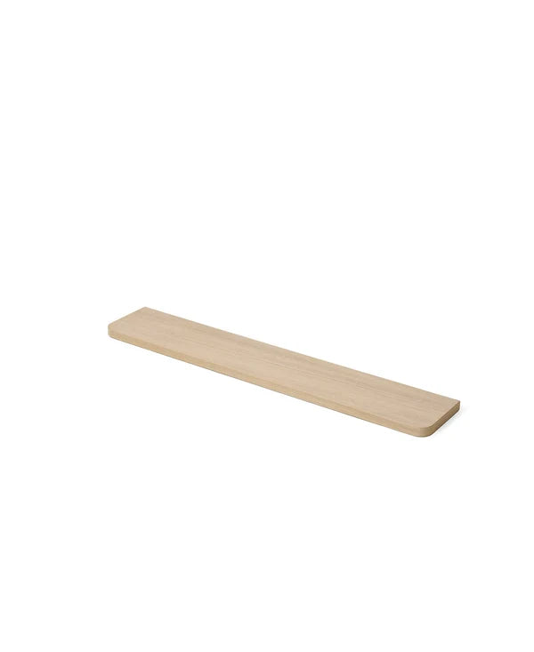 Long, narrow wood shelf on a white background