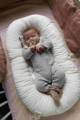 Baby resting in the Amazing Maize Cocoon Baby Lounger in Fog Grey
