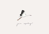 A minimalist art print featuring a black and white flying stork with orange accents, above the handwritten text &