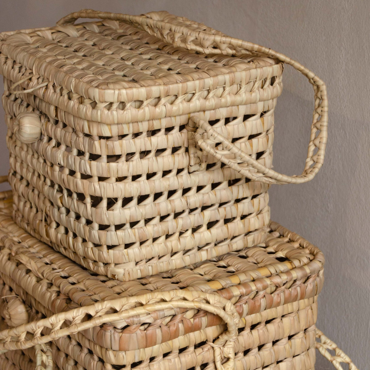 Tine K Home basket with lid open, showing the natural palm leaf storage bin underneath