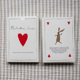 Two Milestone Cards boxes lying on striped linen fabric