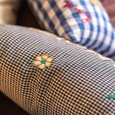 Close-up of the CSAO Amour Cushion in Blue Check print, showing the embroidered detail