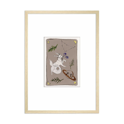 Ingelijste Hazel &amp; George Steenbok-poster met een steenbok, de planeet Saturnus en bloemen op een taupe achtergrond, in een lichte houten lijst