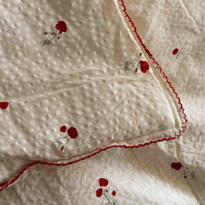 Close-up of the Seersucker Poppy fabric on the Garbo&amp;Friends Filled Blanket