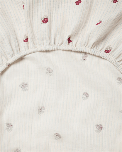 Detail of the Garbo &amp; Friends Muslin Changing Mat Cover Rosehip showing the elastic hem and fine pinstripe muslin
