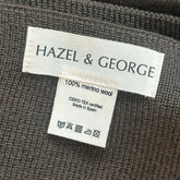 Close-up of the Hazel & George label reading 100% merino wool, OEKO-TEX certified, Made in Spain, on a Merino Blanket in Mosswood