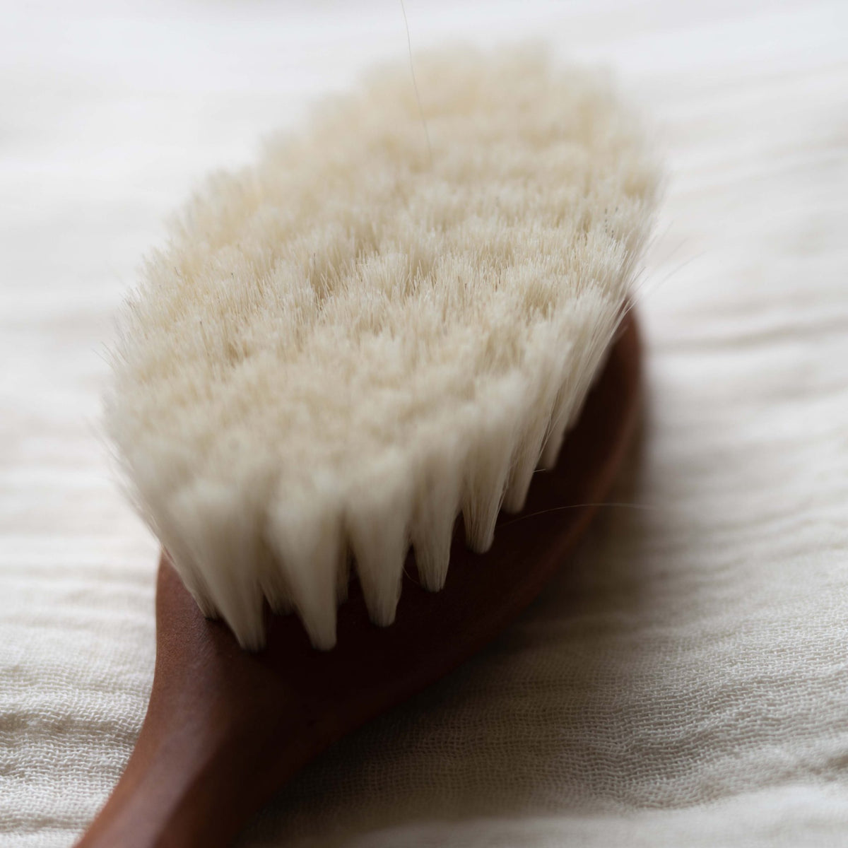 Close-up of the soft cream bristles of the Hazel &amp; George wooden baby hair brush